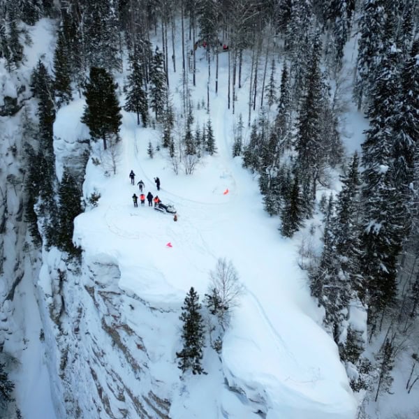 Aerial view of a search and rescue team on a snowy mountain