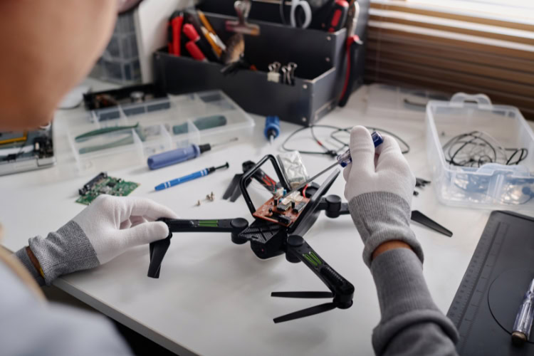 A person is doing a repair on a drone.